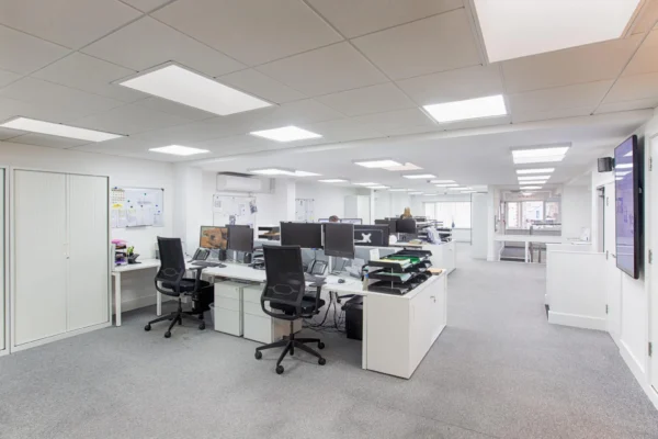Modern open office space with desks and computers