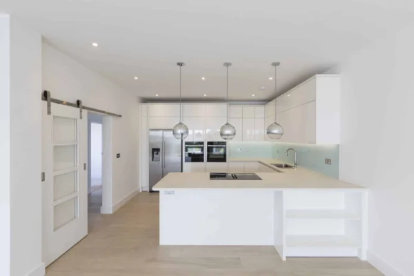 Modern white kitchen with island and sliding door