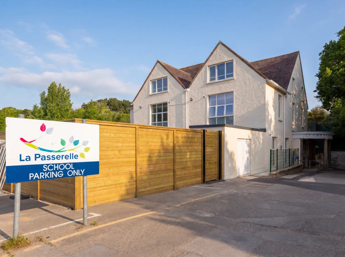 School entrance with parking sign and building exterior.