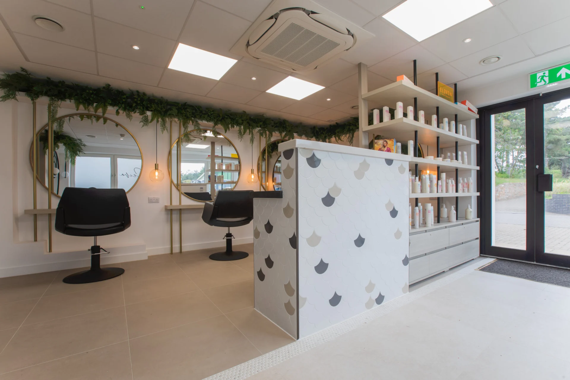 Modern salon interior with mirrors and product display.