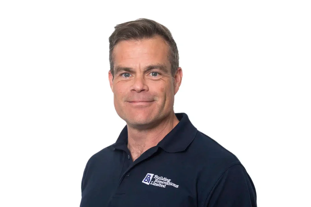 Man in navy polo shirt smiling