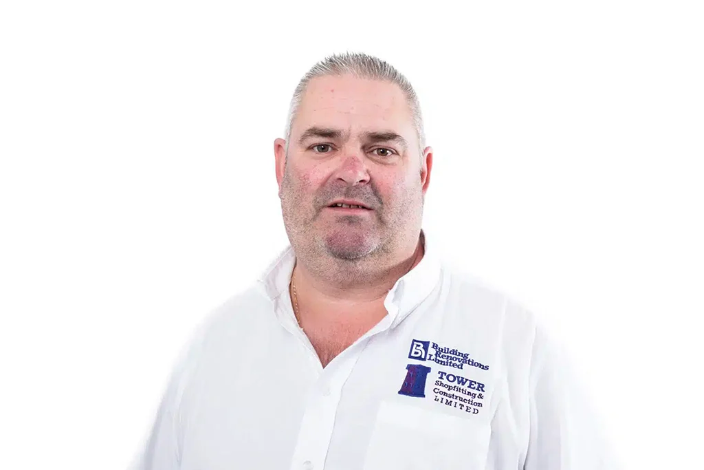 Man wearing a company-branded shirt on white background.
